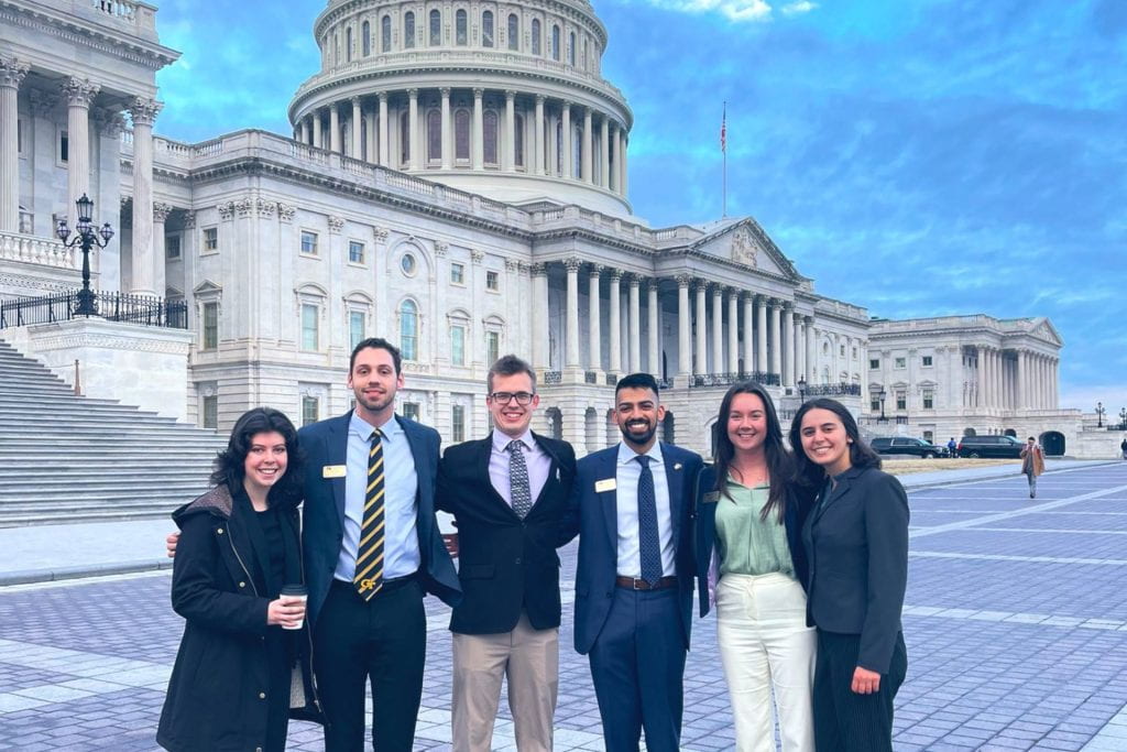 Five students stand in front of the U.S. Capital building.